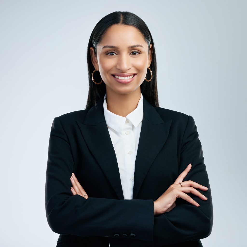 Shot of a confident young businesswoman standing against a grey background