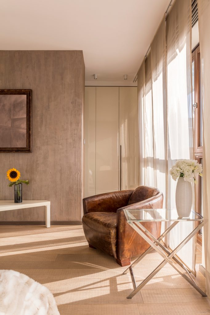 Vintage armchair and flowers in room