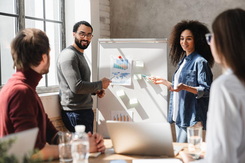Business men and women share ideas, work on projects, and demonstrate leadership.