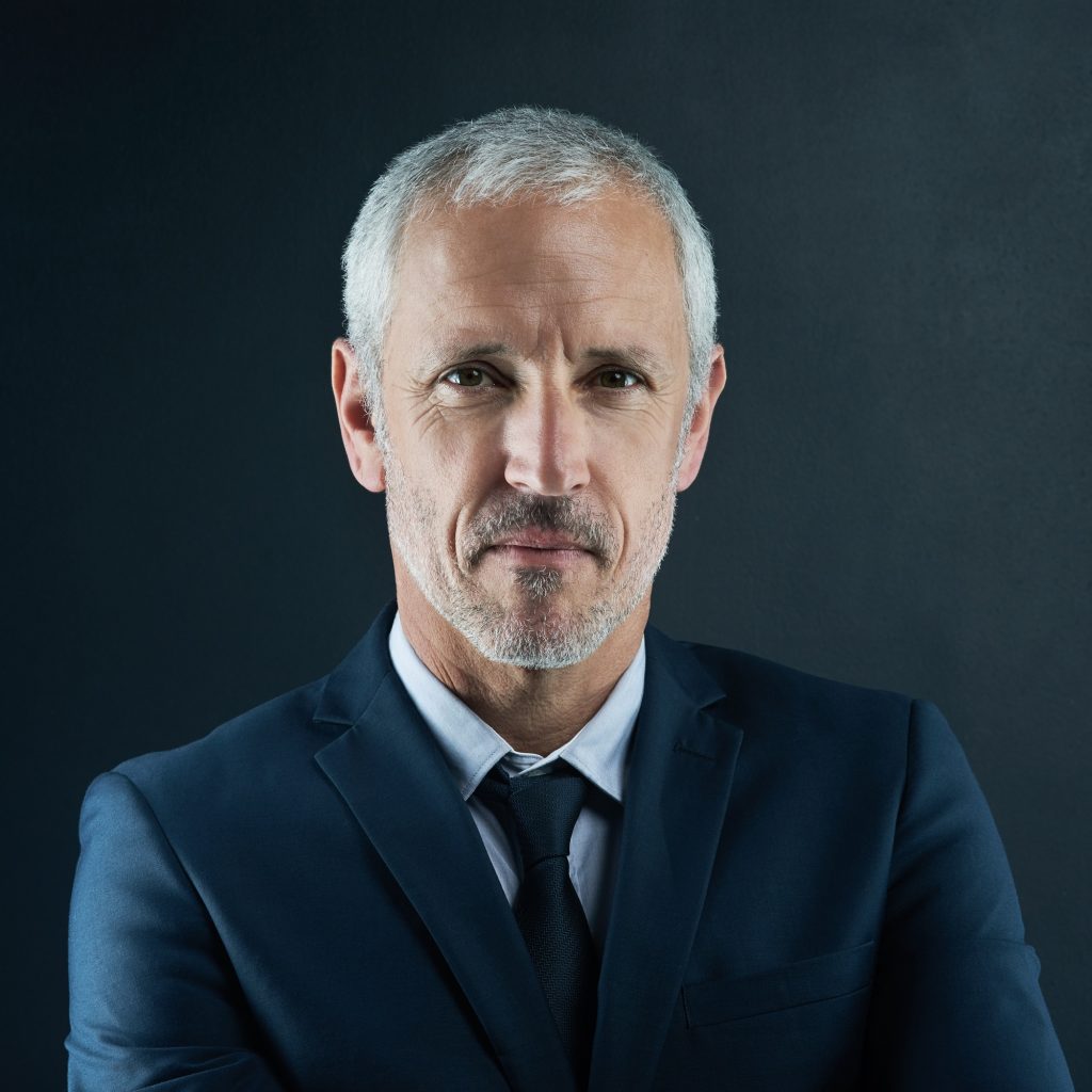 Studio portrait of a mature businessman against a dark background