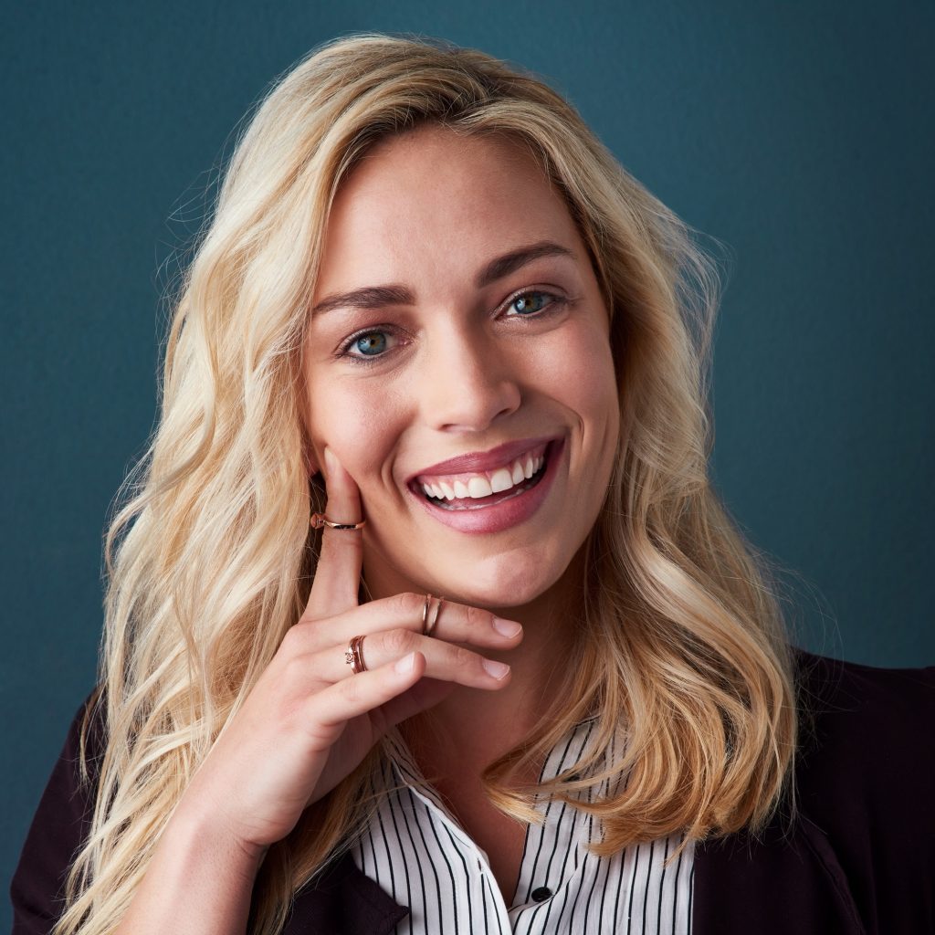 Studio shot of a beautiful young businesswoman posing against a blue background