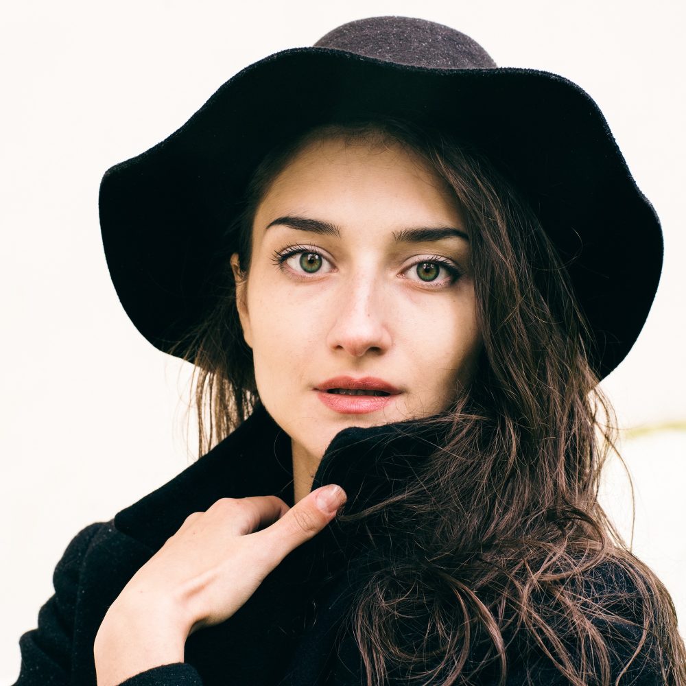 Woman in black coat and hat