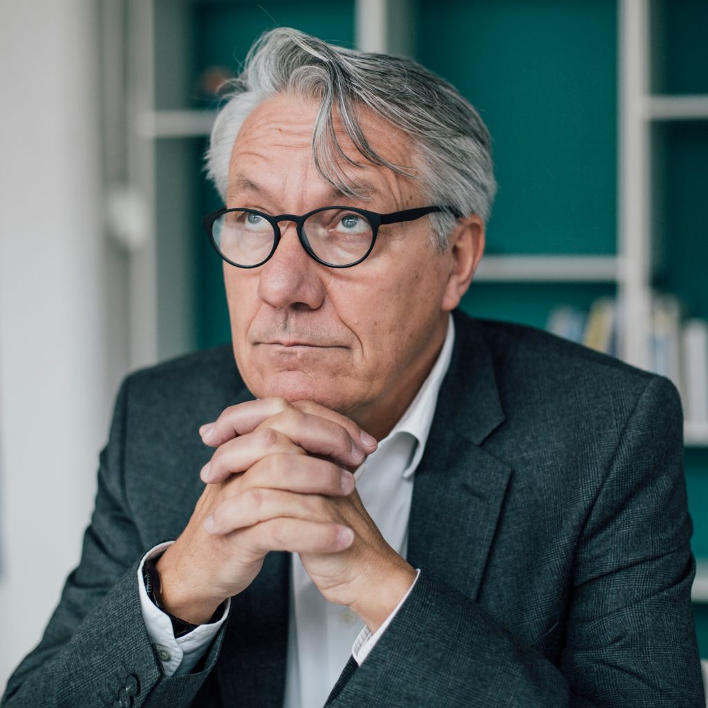 Portrait of senior businessman looking up