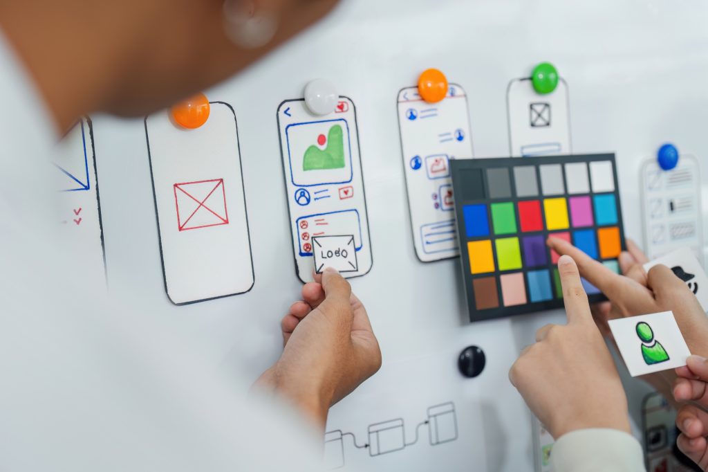 UI designer and UX developer brainstorm idea to design the application interface. Creative digital