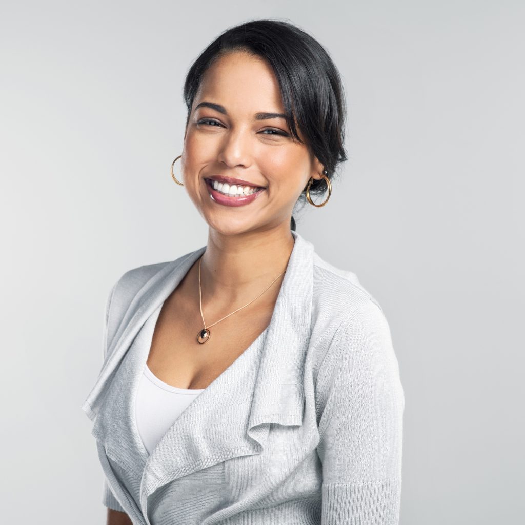 Studio shot of a confident young businesswoman posing against a grey background