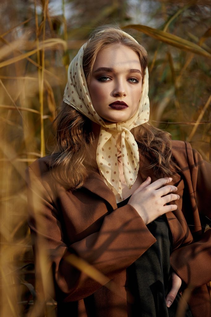 Beautiful portrait of a woman in the village countryside in nature in autumn