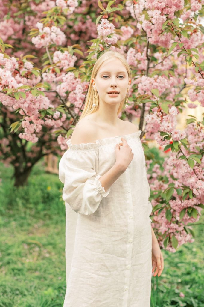 Gorgeous female model having fun in blooming Paris garden.