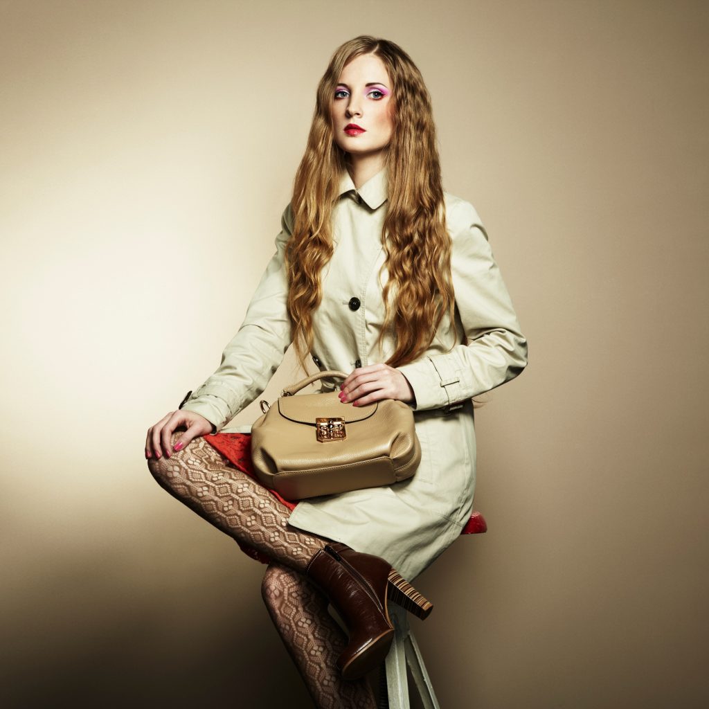 Portrait of a beautiful young woman with a handbag