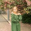 Sensual blond girl in pink linen dress walking in park.